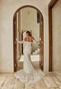 Chessy - Stella's Bridal A fitted wedding dress in lace, featuring dripping pearl beading and optional sleeves. Shown in Ivory and designed by Serene by Madi Lane Bridal. A modern bridal gown available at Stella’s Bridal in Westminster, Maryland. Serene by Madi Lane Bridal Style SR2606 Chessy.