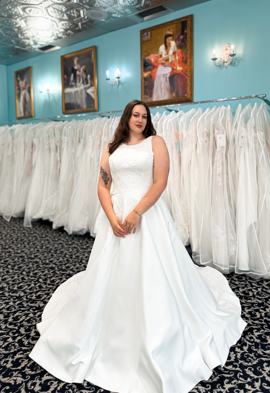 Quinn - Stella's Bridal An a-line wedding dress in matte satin, featuring floral lace and a high neckline. Shown in Ivory and designed by Stella's Collection. A modern bridal gown available at Stella’s Bridal in Westminster, Maryland.