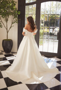 Addison - Stella's Bridal An a-line wedding dress in satin, featuring floral chiffon appliques and detachable off-the-shoulder drapes. Shown in Ivory and designed by Casablanca Bridal. A modern bridal gown available at Stella’s Bridal in Westminster, Maryland. Casablanca Bridal Style 2561 Addison.