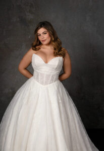 Mariposa - Stella's Bridal A ballgown wedding dress in lace, featuring a cat-eye neckline and basque waist. Shown in Ivory and designed by Essense of Australia Bridal. A modern bridal gown available at Stella’s Bridal in Westminster, Maryland. Essense of Australia style D4270.