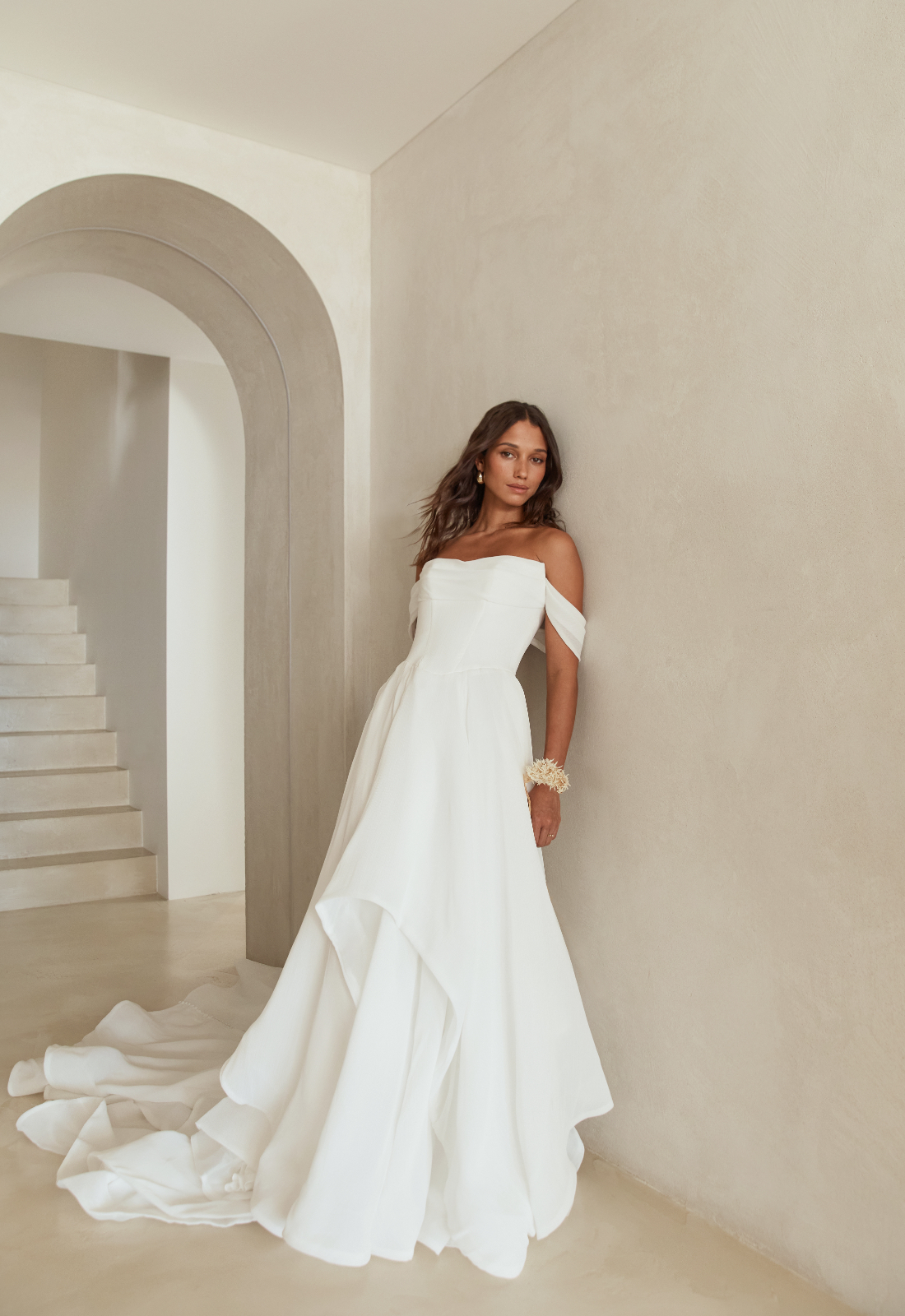 Cherry Rae - Stella's Bridal Serene by Madi Lane Cherry Rae wedding dress featuring an a-line silhouette with straight neckline, ruffled chiffon skirt, and corseted details. Available at Stella’s Bridal in Westminster, Maryland.