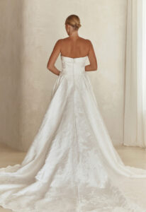Serene by Madi Lane Clea wedding dress featuring an a-line silhouette with straight neckline, brocade skirt, and waterfall basque details. Available at Stella’s Bridal in Westminster, Maryland.