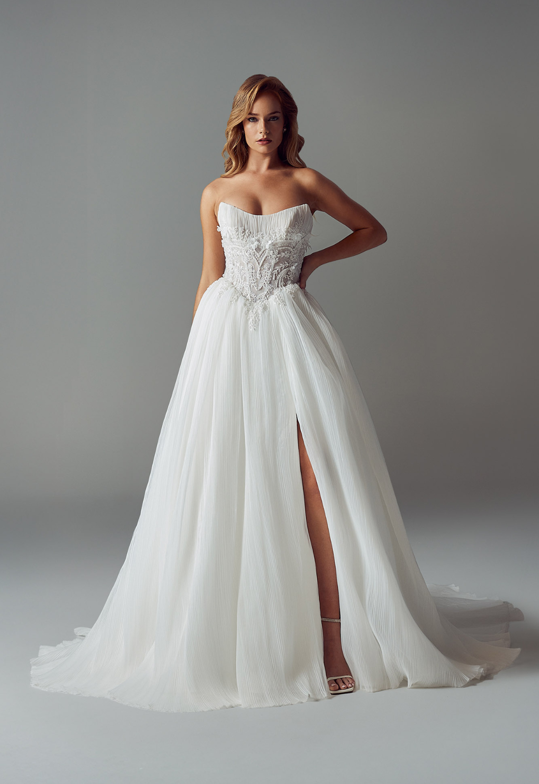 Evie Young Delilah wedding dress featuring an a-line silhouette with scoop neckline, pleated chiffon skirt, and sparkling lace details. Available at Stella’s Bridal in Westminster, Maryland.