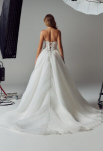 Evie Young Delilah wedding dress featuring an a-line silhouette with scoop neckline, pleated chiffon skirt, and sparkling lace details. Available at Stella’s Bridal in Westminster, Maryland.