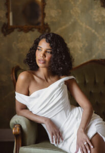 Ellowen - Stella's Bridal Essense of Australia D4563 wedding dress featuring a fitted silhouette with straight neckline, crepe skirt, and ruched details. Available at Stella’s Bridal in Westminster, Maryland.