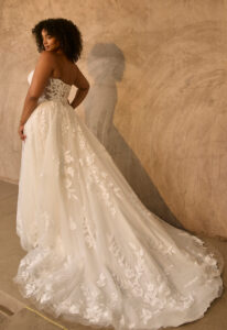 Garnet - Stella's Bridal Beloved by Casablanca Garnet wedding dress featuring an a-line silhouette with cat-eye neckline, tulle skirt, and lace details. Available at Stella’s Bridal in Westminster, Maryland.