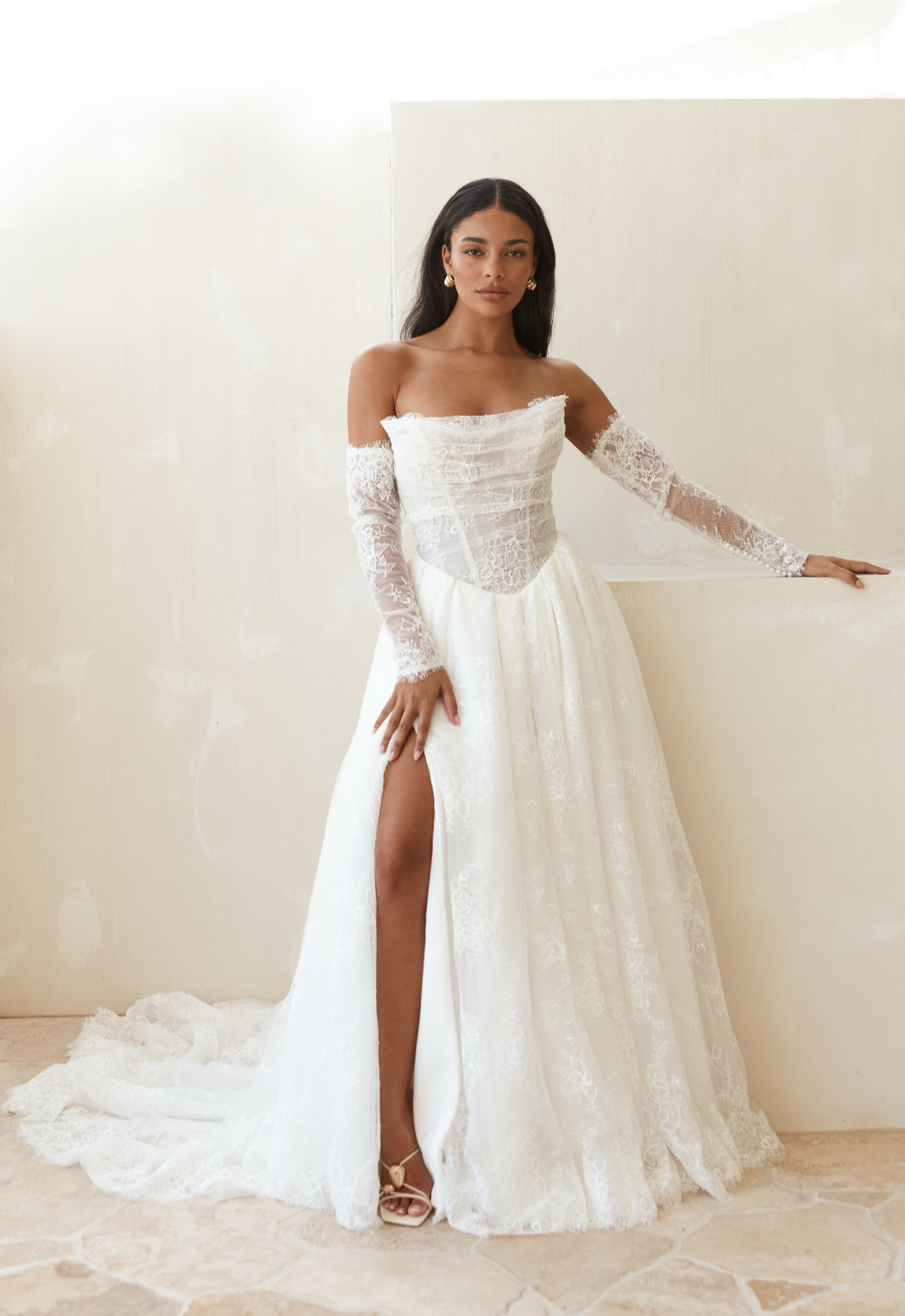 Serene by Madi Lane Lilac wedding dress featuring an a-line silhouette with straight neckline, lace skirt, and basque waist details. Available at Stella’s Bridal in Westminster, Maryland.