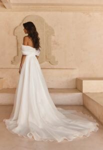 Lissy - Stella's Bridal Serene by Madi Lane Lissy wedding dress featuring an a-line silhouette with straight neckline, organza skirt, and pleated details. Available at Stella’s Bridal in Westminster, Maryland.