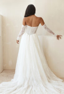 Serene by Madi Lane Lilac wedding dress featuring an a-line silhouette with straight neckline, lace skirt, and basque waist details. Available at Stella’s Bridal in Westminster, Maryland.