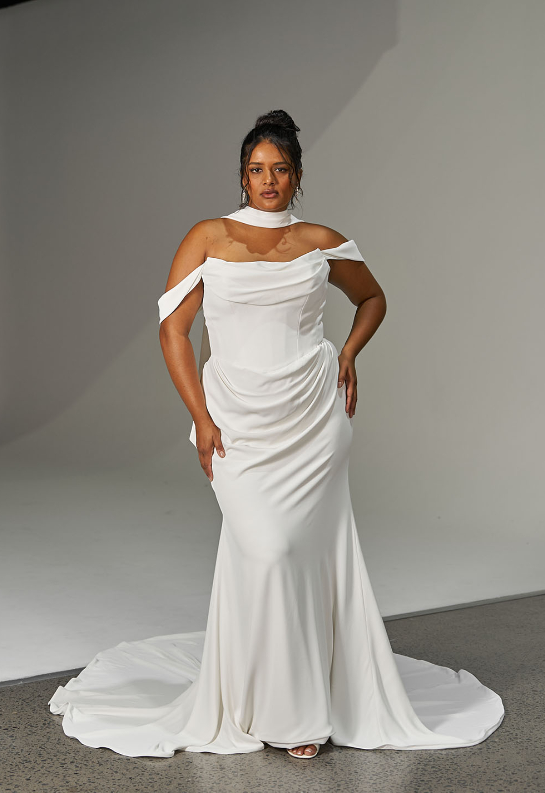 Loren - Stella's Bridal Evie Young Loren wedding dress featuring a fitted silhouette with scoop neckline, liquid satin skirt, and ruched lace details. Available at Stella’s Bridal in Westminster, Maryland.