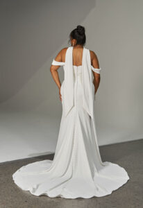 Loren - Stella's Bridal Evie Young Loren wedding dress featuring a fitted silhouette with scoop neckline, liquid satin skirt, and ruched lace details. Available at Stella’s Bridal in Westminster, Maryland.