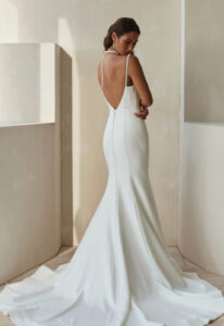 Novalis - Stella's Bridal Serene by Madi Lane Novalis wedding dress featuring a sheath silhouette with square neckline, crepe skirt, and beaded details. Available at Stella’s Bridal in Westminster, Maryland.