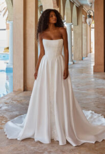 Olexa - Stella's Bridal Madi Lane Olexa wedding dress featuring an a-line silhouette with scoop neckline, satin skirt, and lace details. Available at Stella’s Bridal in Westminster, Maryland.