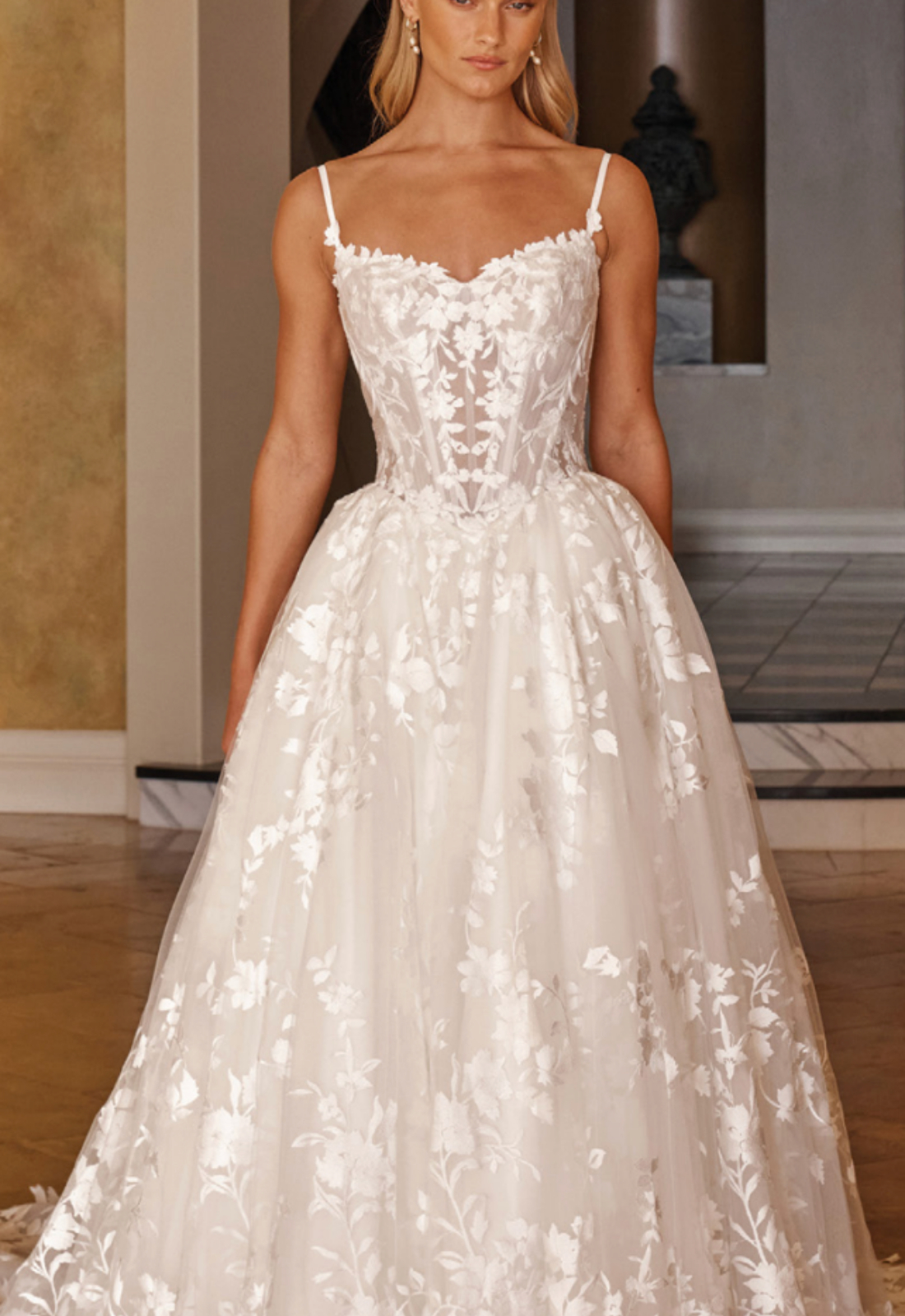 Madi Lane Ozana wedding dress featuring a ballgown silhouette with sweetheart neckline, boho lace skirt, and corseted details. Available at Stella’s Bridal in Westminster, Maryland.