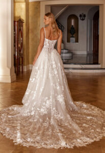Ozana - Stella's Bridal Madi Lane Ozana wedding dress featuring a ballgown silhouette with sweetheart neckline, boho lace skirt, and corseted details. Available at Stella’s Bridal in Westminster, Maryland.