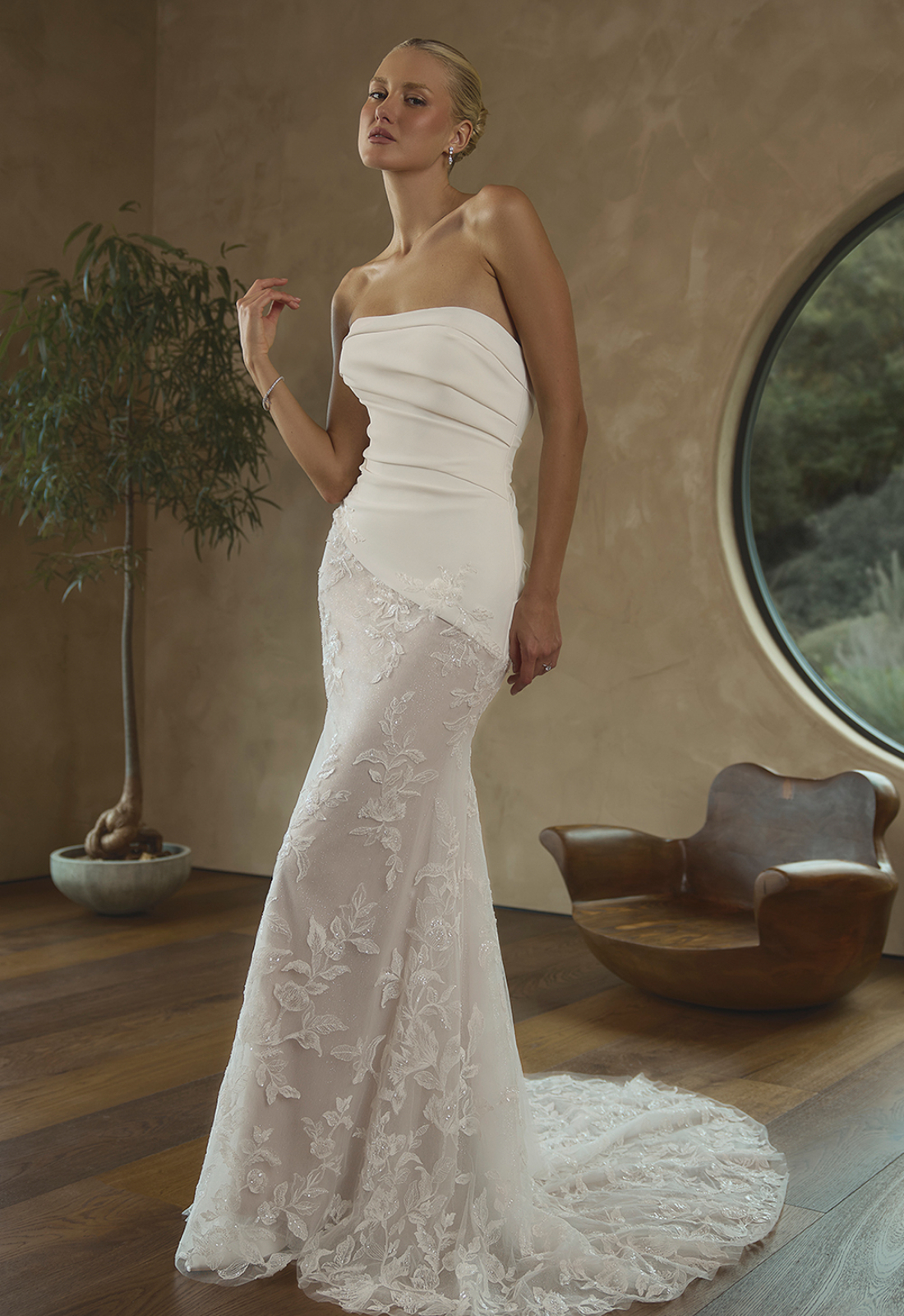 Ridley - Stella's Bridal Casablanca Ridely wedding dress featuring a fitted silhouette with straight neckline, asymmetrical lace skirt, and ruched crepe details. Available at Stella’s Bridal in Westminster, Maryland.