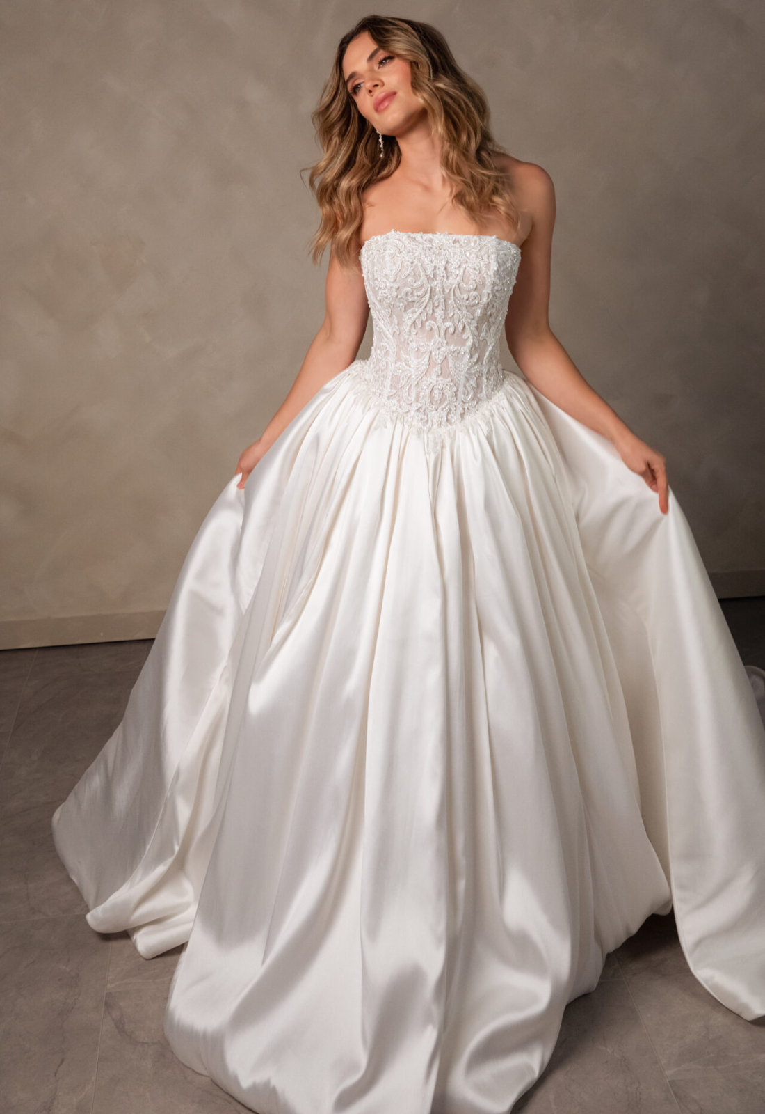 Romy Essense of Australia D4546 wedding dress featuring a ballgown silhouette with straight neckline, satin skirt, and beaded details. Available at Stella’s Bridal in Westminster, Maryland.