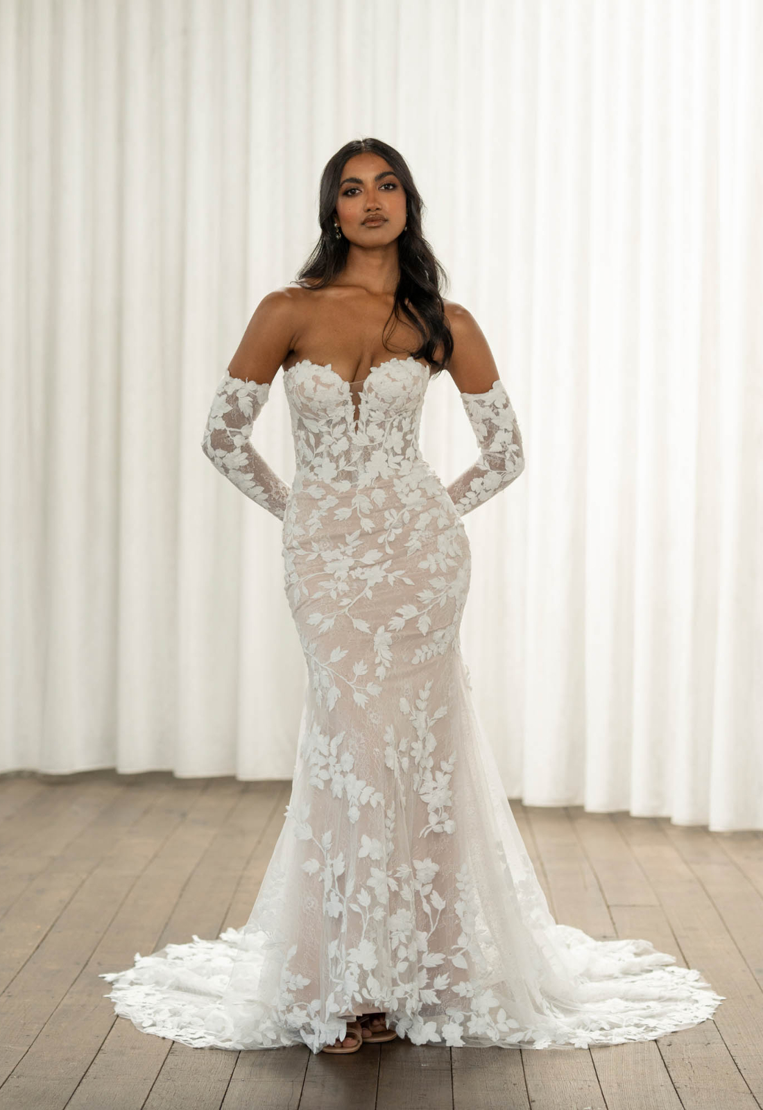 Thane - Stella's Bridal Madi Lane Thane wedding dress featuring a fitted silhouette with sweetheart neckline, boho lace skirt, and corseted details. Available at Stella’s Bridal in Westminster, Maryland.
