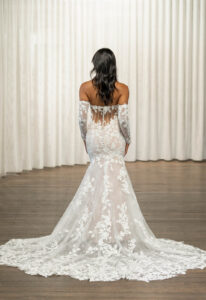 Thane - Stella's Bridal Madi Lane Thane wedding dress featuring a fitted silhouette with sweetheart neckline, boho lace skirt, and corseted details. Available at Stella’s Bridal in Westminster, Maryland.