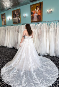 Lulu - Stella's Bridal Love it at Stella's Exclusive Lulu wedding dress featuring an a-line silhouette with cat eye neckline, scroll lace skirt, and sparkling details. Available at Stella’s Bridal in Westminster, Maryland.