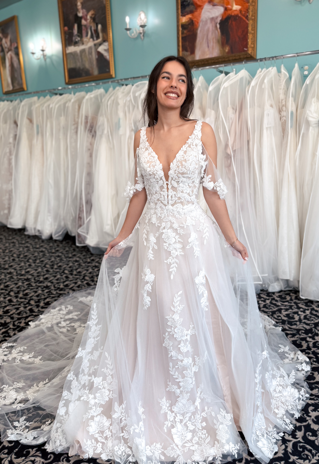 Rosalin - Stella's Bridal Love it at Stella's Exclusive Rosalin wedding dress featuring an a-line silhouette with v-neck neckline, flutter sleeves, and floral lace details. Available at Stella’s Bridal in Westminster, Maryland.
