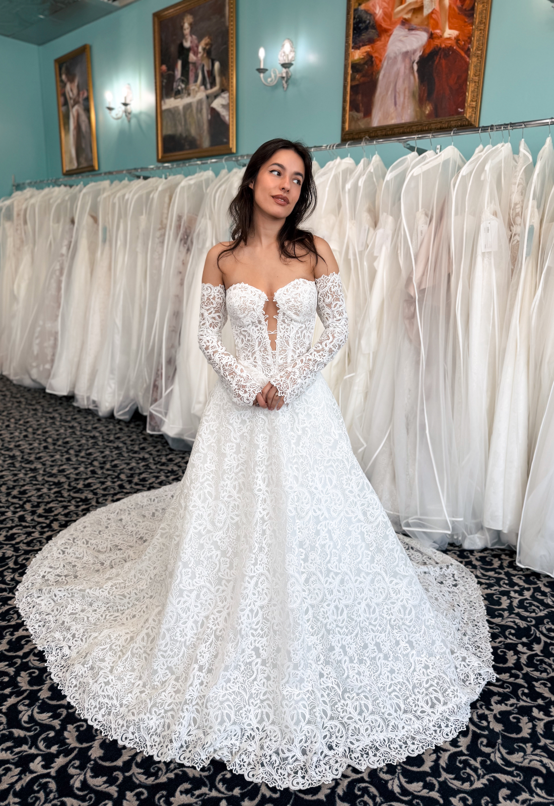 Ophelia - Stella's Bridal Love it at Stella's Exclusive Ophelia wedding dress featuring an a-line silhouette with cut-out sweetheart neckline, detachable sleeves, and illustrative lace details. Available at Stella’s Bridal in Westminster, Maryland.