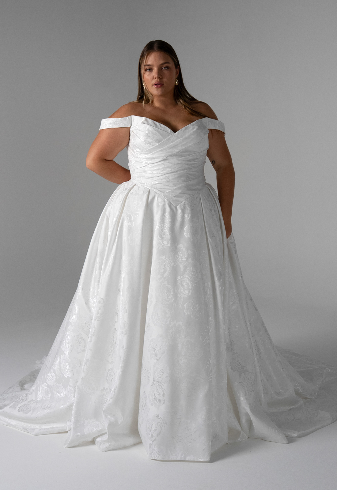 Amanda - Stella's Bridal Serene by Madi Lane Amanda wedding dress featuring a ballgown silhouette with scoop neckline, jacquard satin skirt, and ruched details. Available at Stella’s Bridal in Westminster, Maryland.