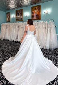 A wedding gown from Stella's Private Collection featuring exclusive bridal design elements such as intricate lace, elegant draping, luxurious fabrics, and timeless silhouettes. Each gown is uniquely curated and available exclusively at Love it at Stella's Bridal.