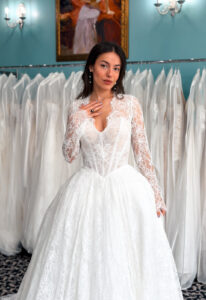 A wedding gown from Stella's Private Collection featuring exclusive bridal design elements such as intricate lace, elegant draping, luxurious fabrics, and timeless silhouettes. Each gown is uniquely curated and available exclusively at Love it at Stella's Bridal.