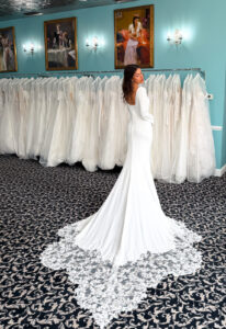 A wedding gown from Stella's Private Collection featuring exclusive bridal design elements such as intricate lace, elegant draping, luxurious fabrics, and timeless silhouettes. Each gown is uniquely curated and available exclusively at Love it at Stella's Bridal.