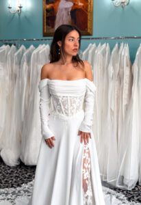A wedding gown from Stella's Private Collection featuring exclusive bridal design elements such as intricate lace, elegant draping, luxurious fabrics, and timeless silhouettes. Each gown is uniquely curated and available exclusively at Love it at Stella's Bridal.