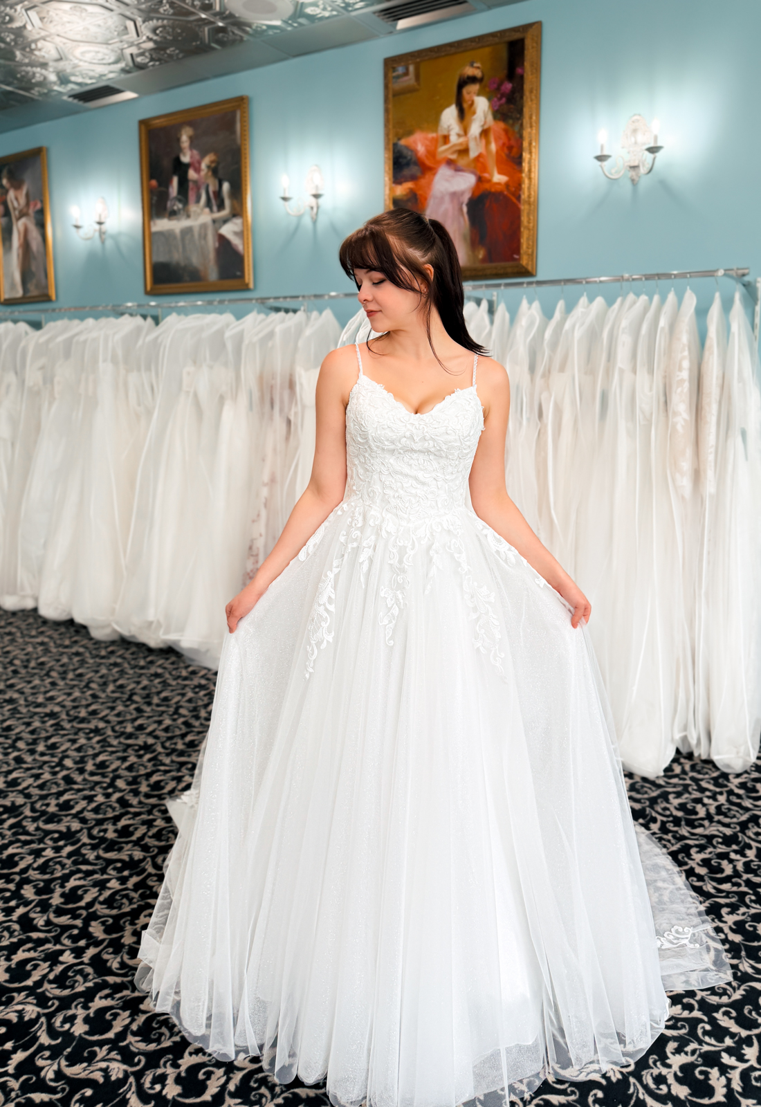 A wedding gown from Stella's Private Collection featuring exclusive bridal design elements such as intricate lace, elegant draping, luxurious fabrics, and timeless silhouettes. Each gown is uniquely curated and available exclusively at Love it at Stella's Bridal.