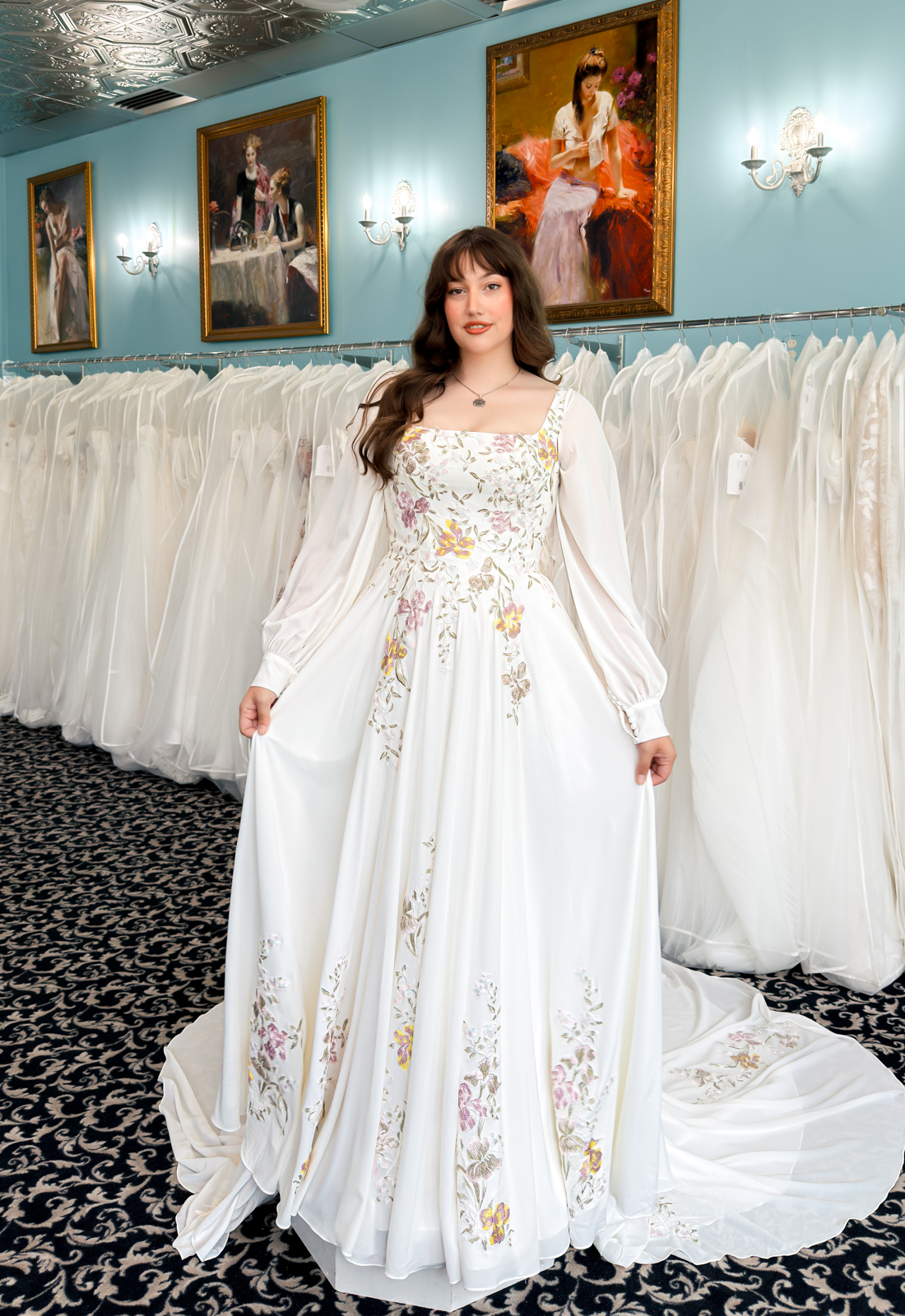 A wedding gown from Stella's Private Collection featuring exclusive bridal design elements such as intricate lace, elegant draping, luxurious fabrics, and timeless silhouettes. Each gown is uniquely curated and available exclusively at Love it at Stella's Bridal.