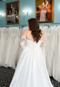A wedding gown from Stella's Private Collection featuring exclusive bridal design elements such as intricate lace, elegant draping, luxurious fabrics, and timeless silhouettes. Each gown is uniquely curated and available exclusively at Love it at Stella's Bridal.
