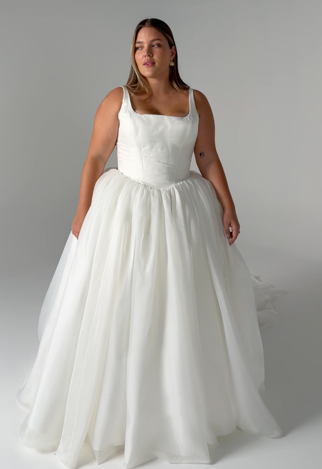 Serene by Madi Lane Mirage wedding dress featuring a ballgown silhouette with square neckline, patterned organza skirt, and pleated details. Available at Stella’s Bridal in Westminster, Maryland.