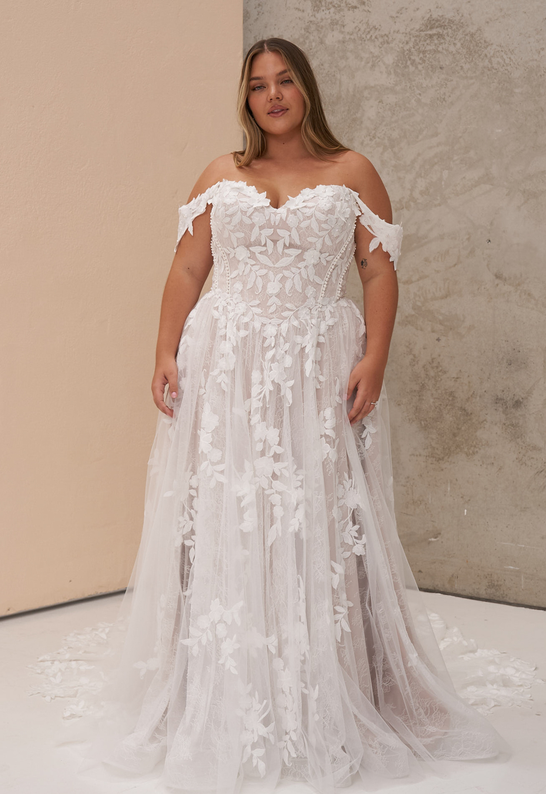 Osha - Stella's Bridal Madi Lane Osha wedding dress featuring an a-line silhouette with sweetheart neckline, boho lace skirt, and corseted details. Available at Stella’s Bridal in Westminster, Maryland.
