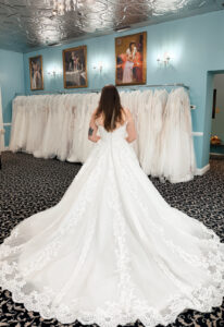 A wedding gown from Stella's Private Collection featuring exclusive bridal design elements such as intricate lace, elegant draping, luxurious fabrics, and timeless silhouettes. Each gown is uniquely curated and available exclusively at Love it at Stella's Bridal.