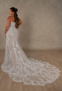 Essense of Australia D4625 Alessandra wedding dress featuring a fitted silhouette, sweetheart neckline, and detailed lace fabric, shown on a curvy model from the back. Available at Love it at Stella's Bridal in Westminster, Maryland