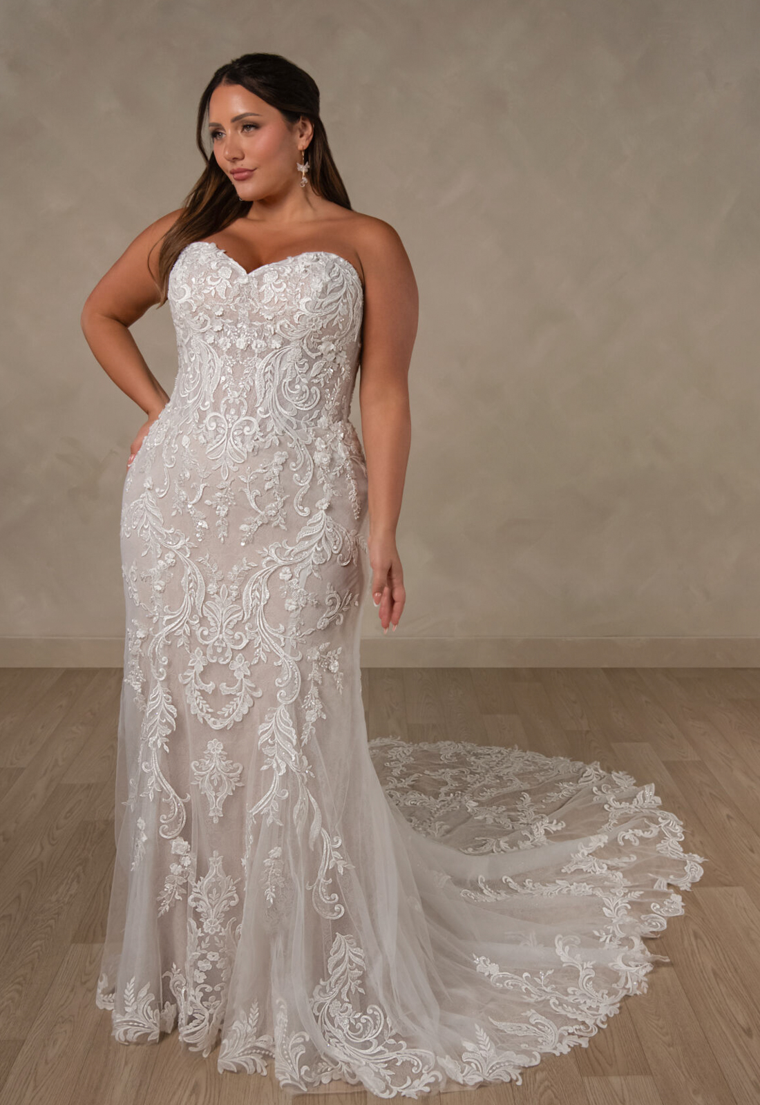 Essense of Australia D4625 Alessandra wedding dress featuring a fitted silhouette, sweetheart neckline, and detailed lace fabric, shown on a curvy model from the front. Available at Love it at Stella's Bridal in Westminster, Maryland
