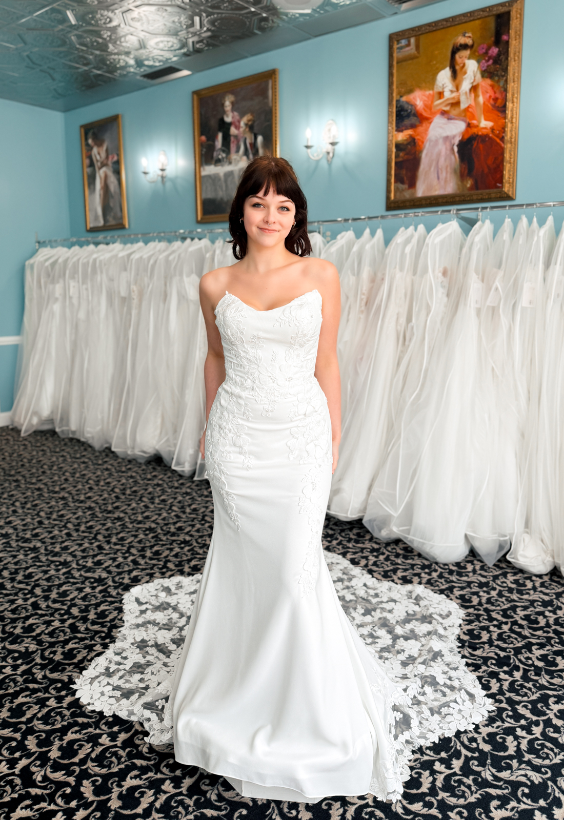 A wedding gown from Stella's Private Collection featuring exclusive bridal design elements such as intricate lace, elegant draping, luxurious fabrics, and timeless silhouettes. Each gown is uniquely curated and available exclusively at Love it at Stella's Bridal.