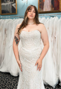 A wedding gown from Stella's Private Collection featuring exclusive bridal design elements such as intricate lace, elegant draping, luxurious fabrics, and timeless silhouettes. Each gown is uniquely curated and available exclusively at Love it at Stella's Bridal.