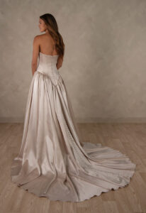 Essense of Australia D4628 Spencer wedding dress featuring a deep basque waist, straight neckline, and satin fabric, shown from the back. Available at Love it at Stella's Bridal in Westminster, Maryland