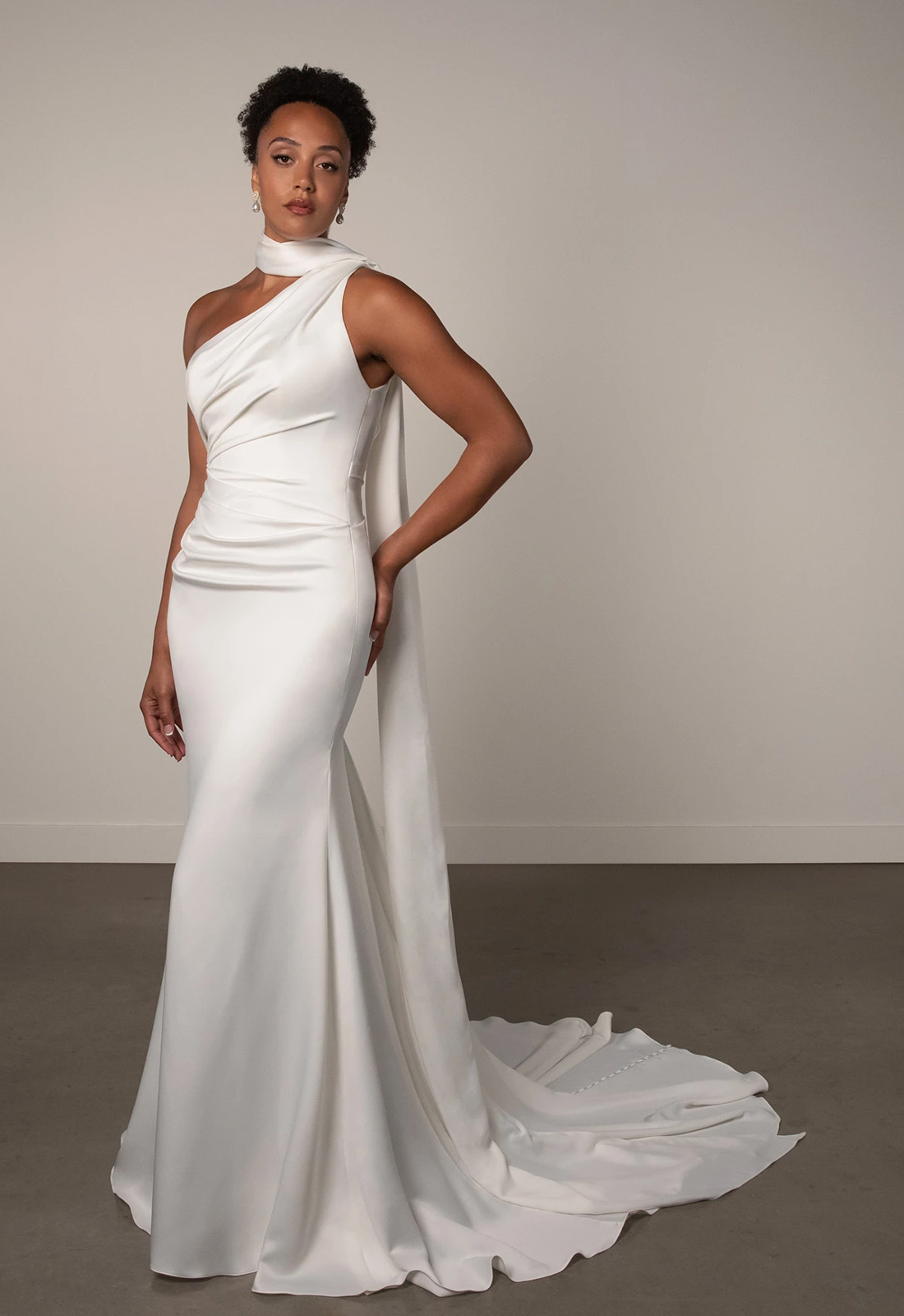 Essense of Australia PA1487 Andie wedding dress featuring a sleek silhouette, one shoulder neckline, and silky satin fabric, shown from the front. Available at Love it at Stella's Bridal in Westminster, Maryland