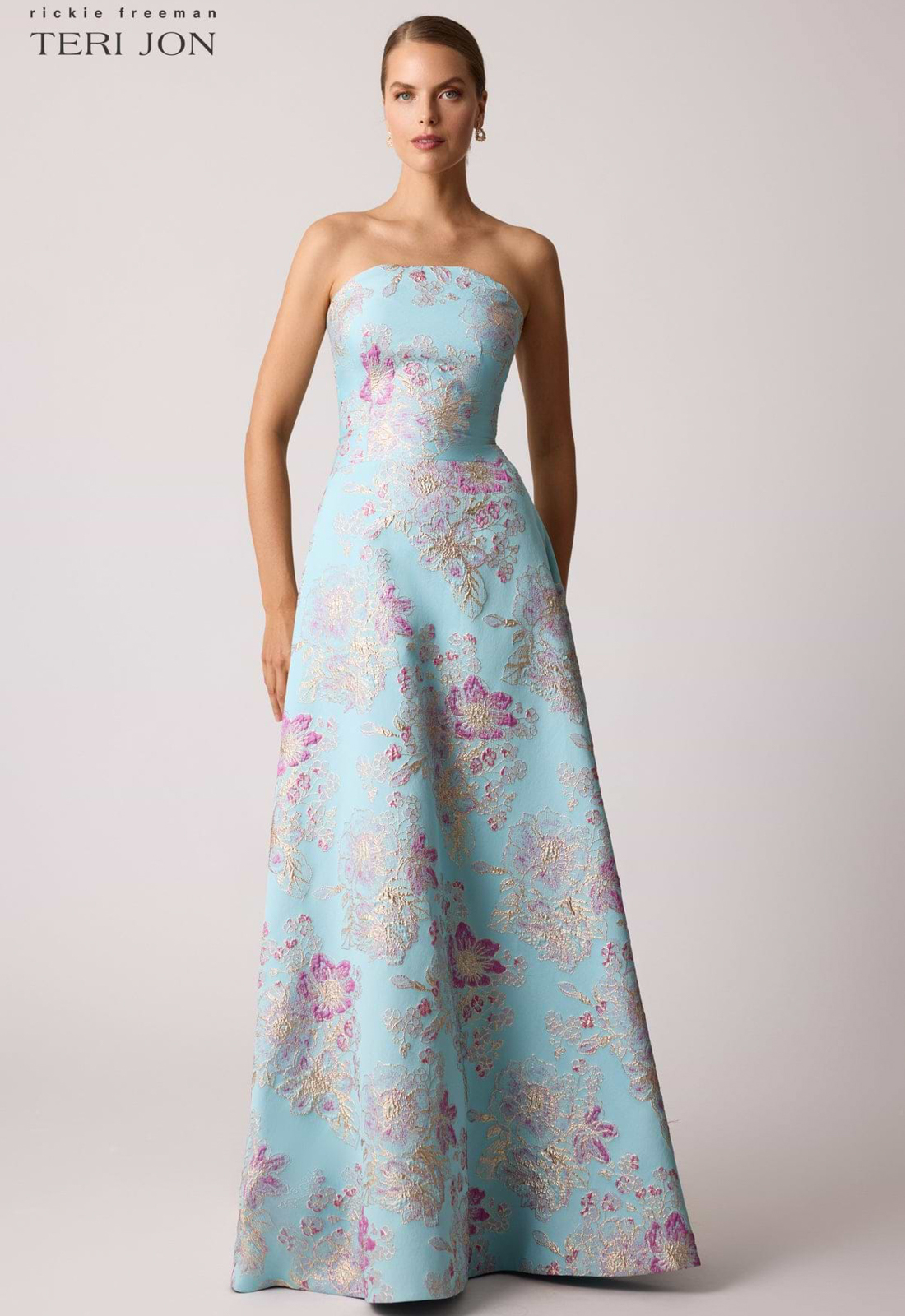 Discover 259019 by Teri Jon, a strapless mother of the bride or groom dress featuring gorgeous brocade fabric. Shop at Stella’s Bridal in Westminster, MD.