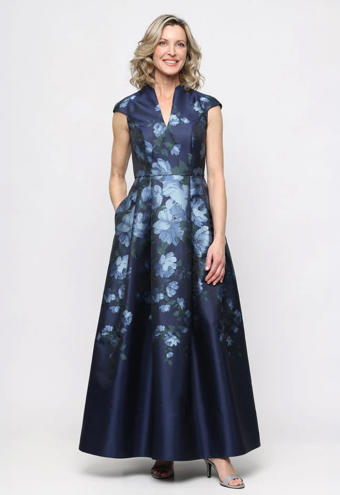 Discover 8181344 by Alex Evenings, a chic flowy mother of the bride or groom dress featuring floral fabric and cap sleeves. Shop at Stella’s Bridal in Westminster, MD.