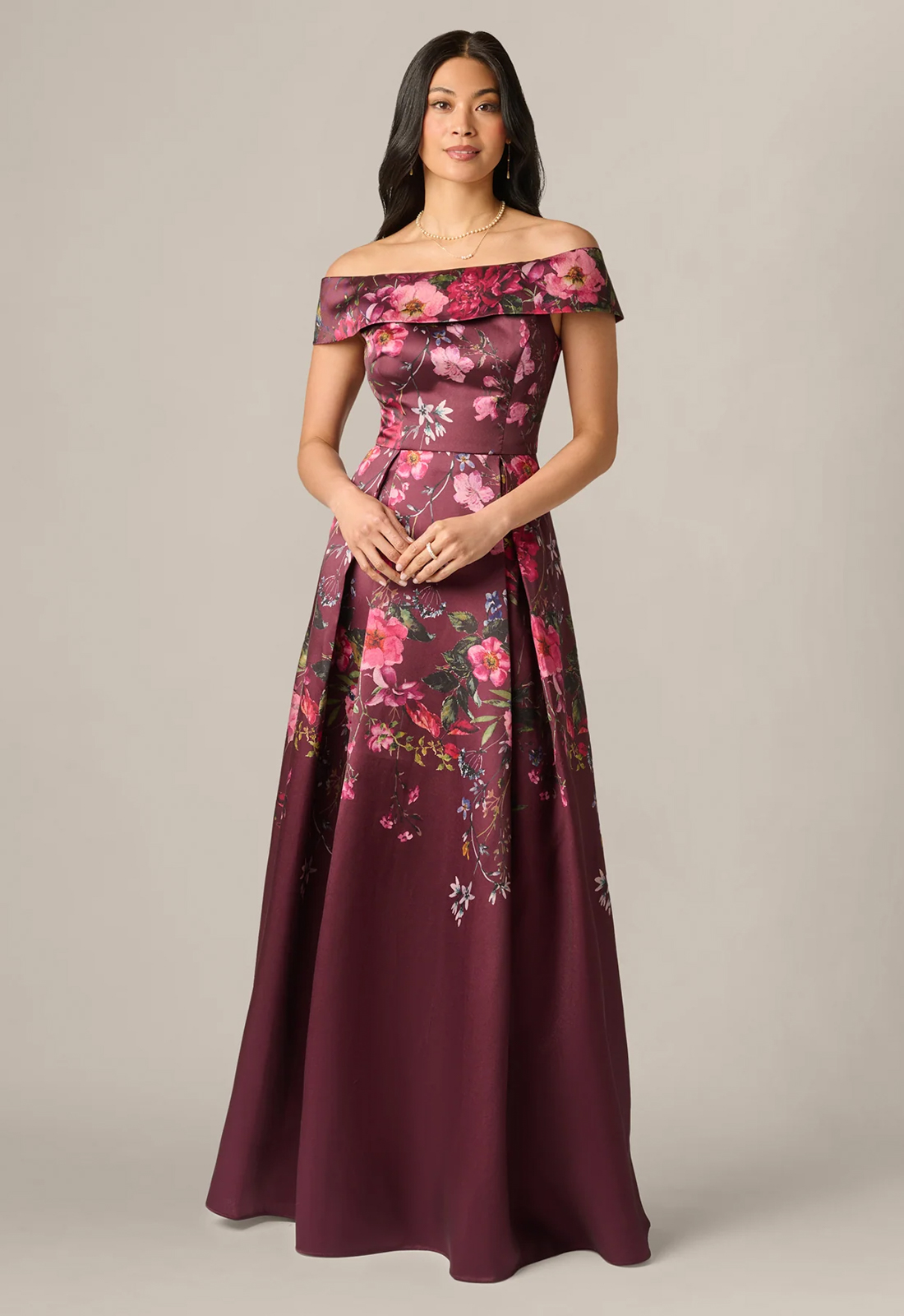Discover AP1E213289 by Adrianna Papell, a flowy mother of the bride or groom dress featuring colorful florals and an off-the-shoulder neckline. Shop at Stella’s Bridal in Westminster, MD.