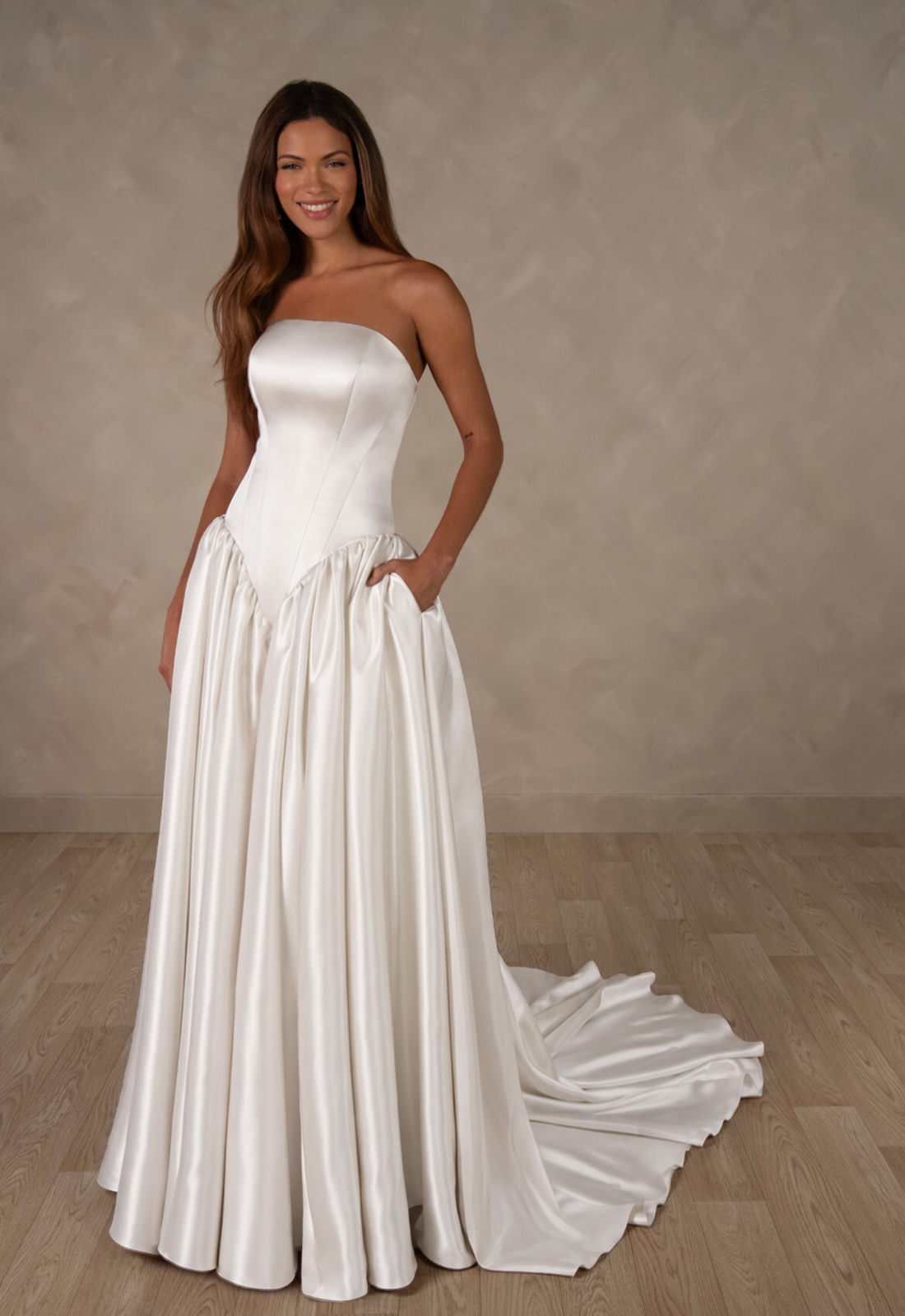 Essense of Australia D4628 Spencer wedding dress featuring a deep basque waist, straight neckline, and satin fabric, shown from the front. Available at Love it at Stella's Bridal in Westminster, Maryland