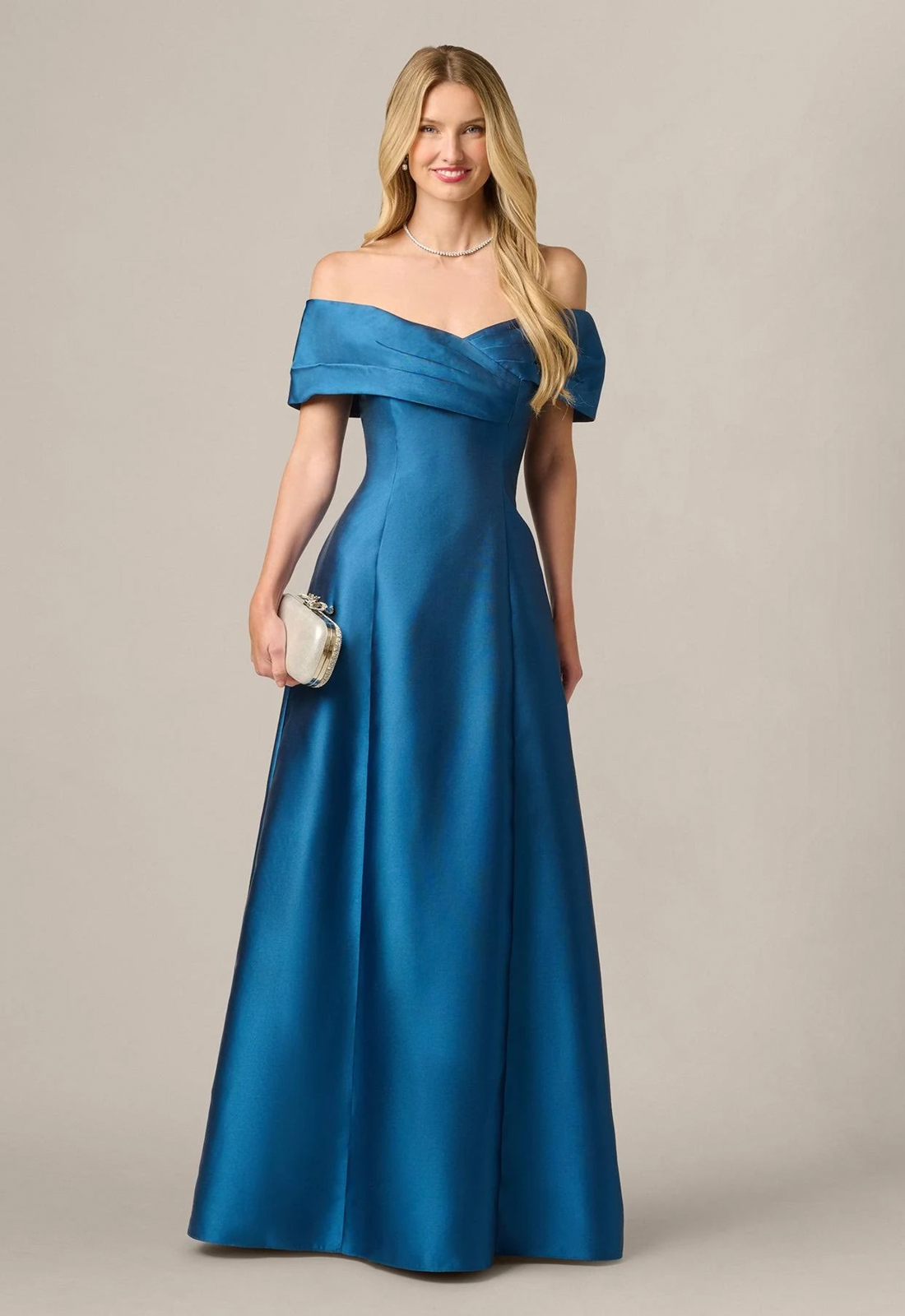 Discover AP1E213401 by Adrianna Papell, a classic flowy mother of the bride or groom dress featuring an off-the-shoulder neckline. Shop at Stella’s Bridal in Westminster, MD.
